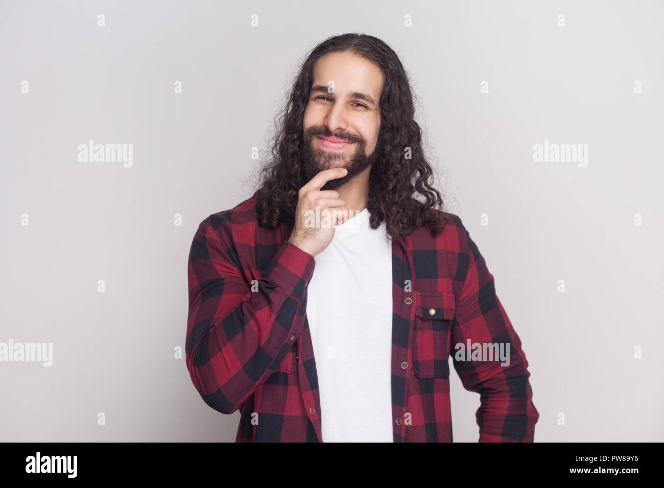 Handsome Man With Beard And Black Long Curly Hair In Casual Style
