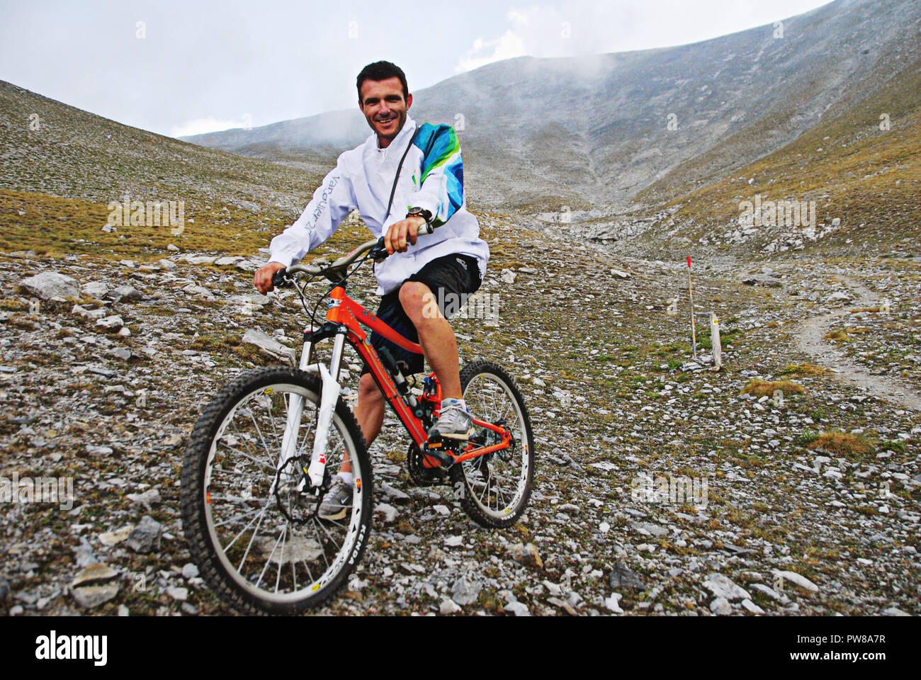 Central Greece, Olympus mountain, a cyclist on the highest peak of mount Olympus, Mytikas summit (2.917 m.), July 27 2012. Stock Photo