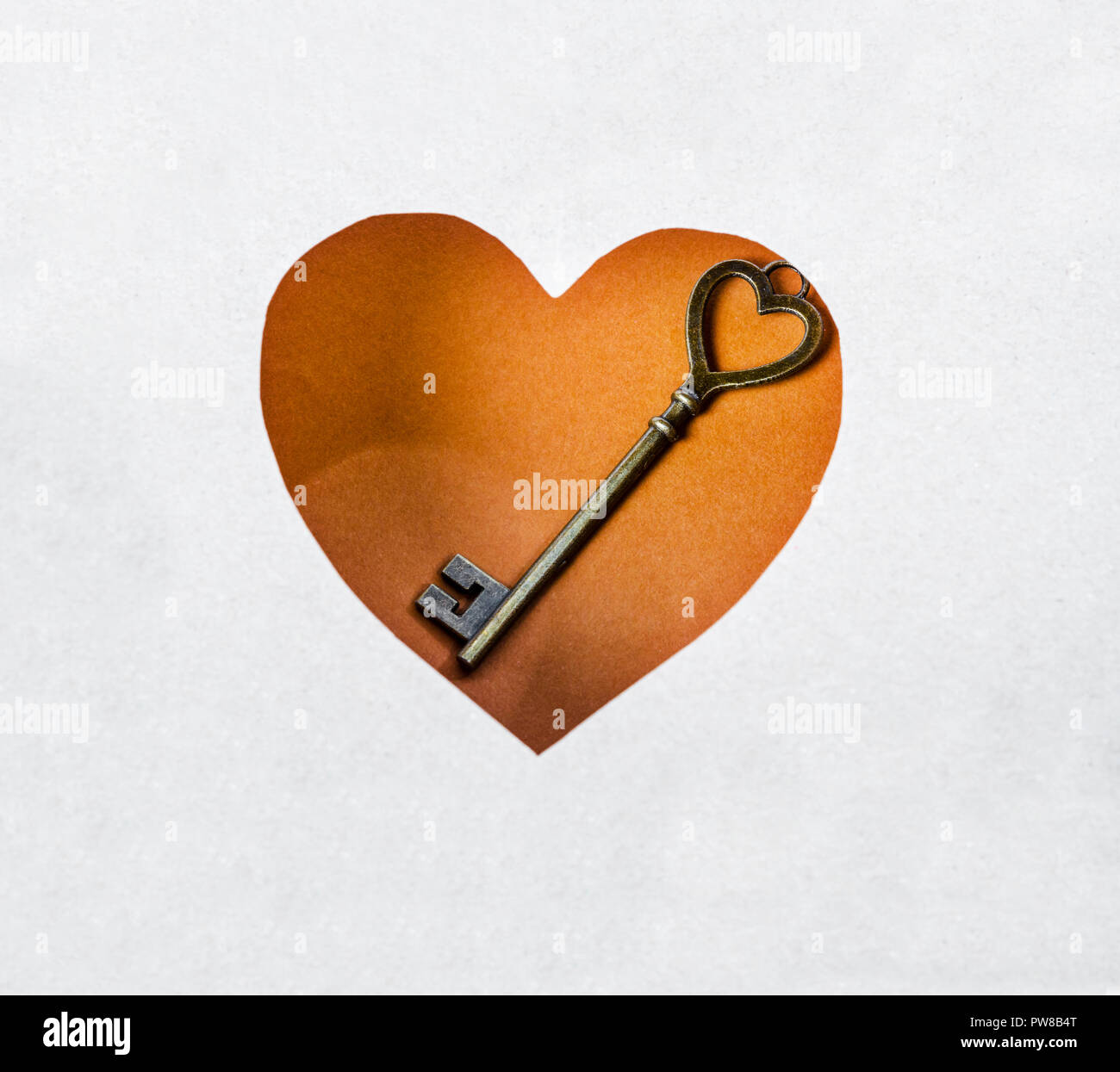 Vintage key on heart paper background Stock Photo - Alamy