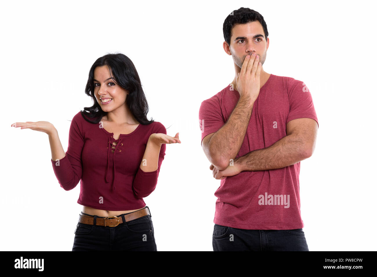 Studio shot of young happy couple smiling with woman shrugging a Stock Photo