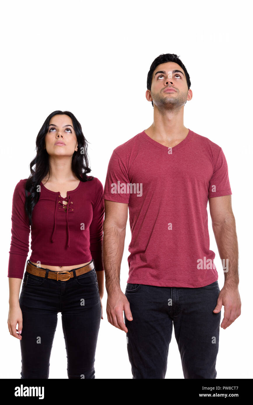 Studio shot of young couple standing and looking up together Stock Photo