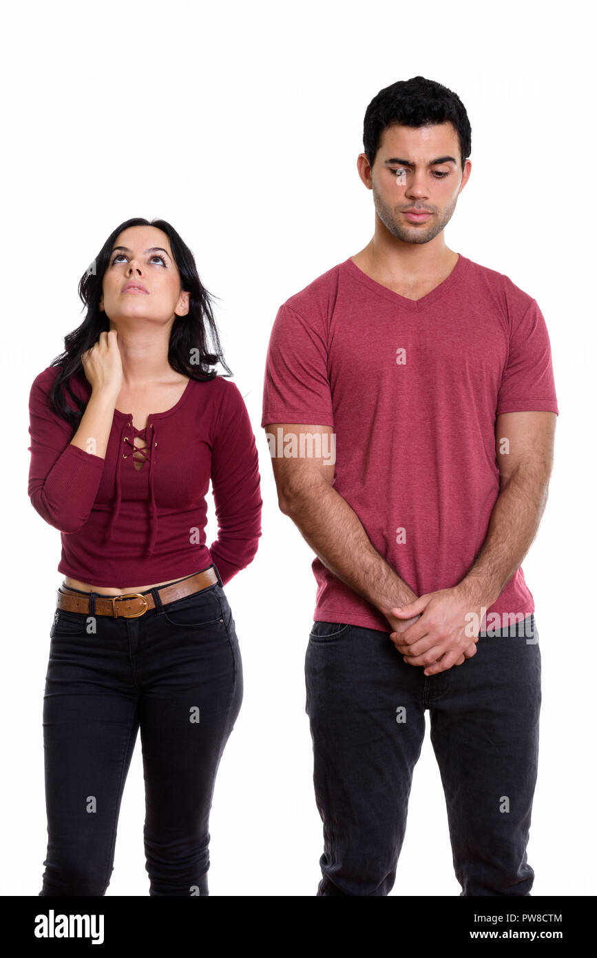 Studio shot of young couple with woman looking up and man lookin Stock Photo