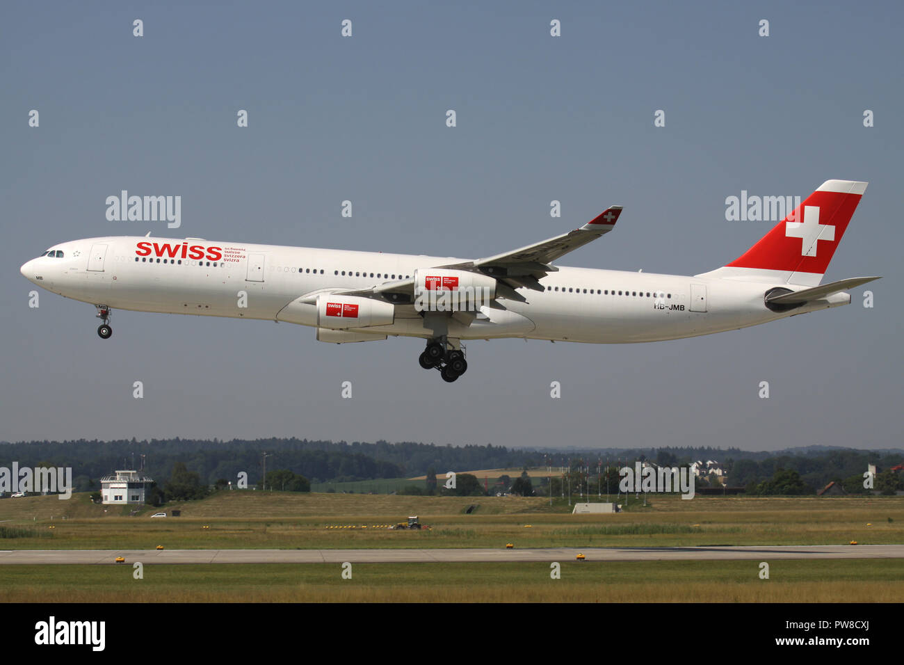 Swiss International Air Lines Airbus A340-300 (old livery) with registration HB-JMB on short final for runway 14 of Zurich Airport. Stock Photo
