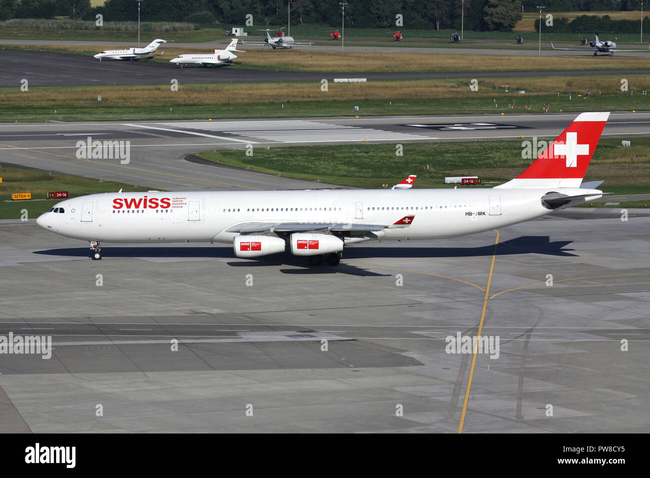 Swiss International Air Lines Airbus A340-300 (old livery) with registration HB-JMK taxiing to runway 34 of Zurich Airport. Stock Photo