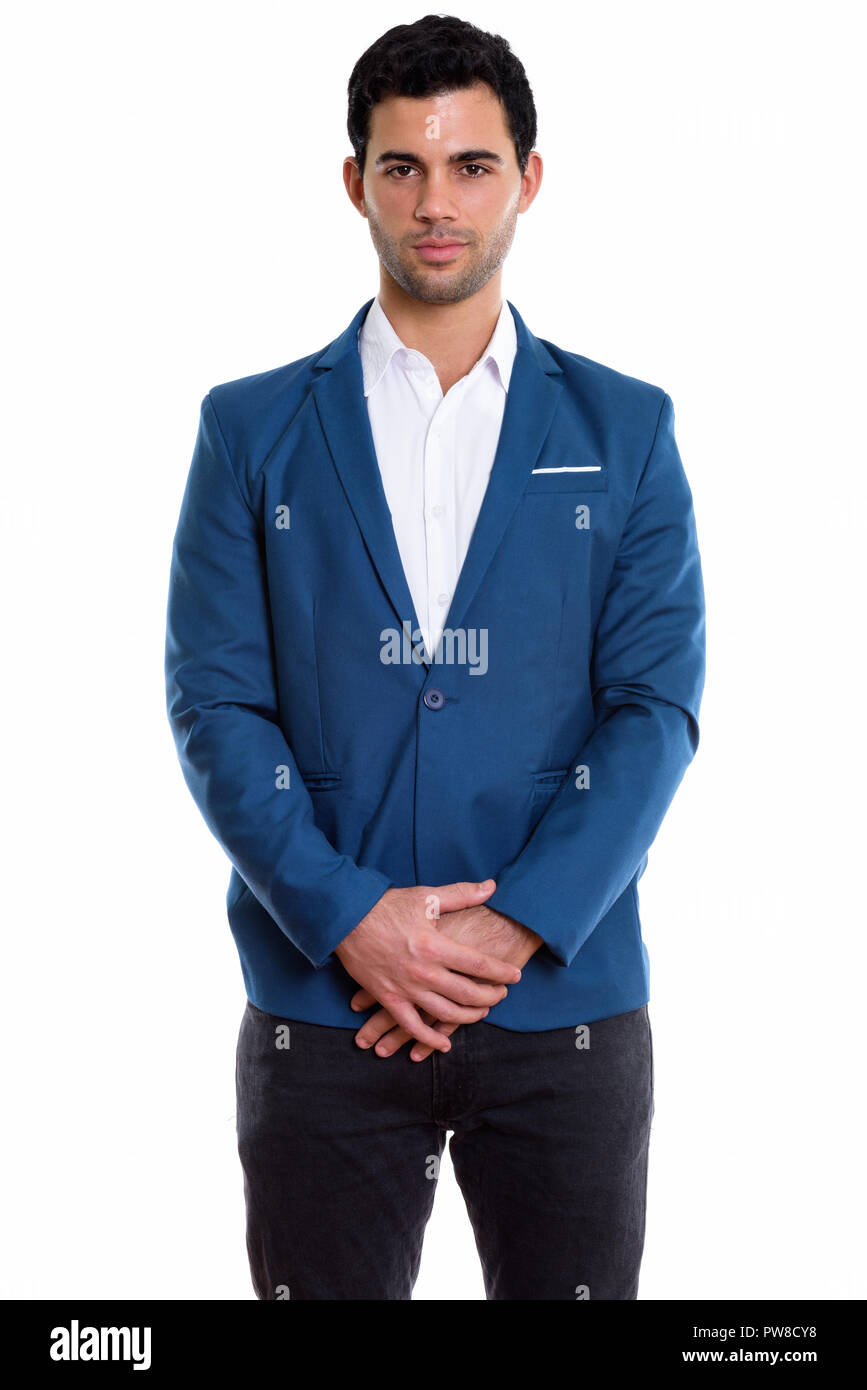 Studio shot of young handsome Hispanic businessman standing Stock Photo