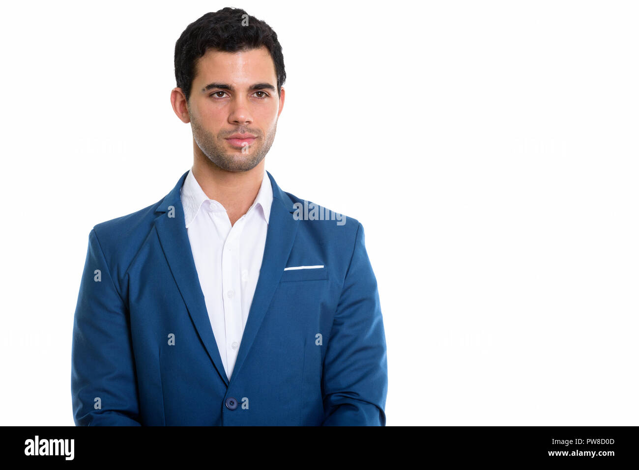 Studio shot of young handsome Hispanic businessman thinking Stock Photo