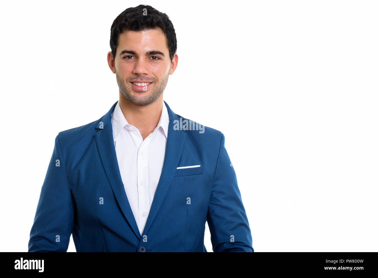 Studio shot of young happy Hispanic businessman smiling Stock Photo