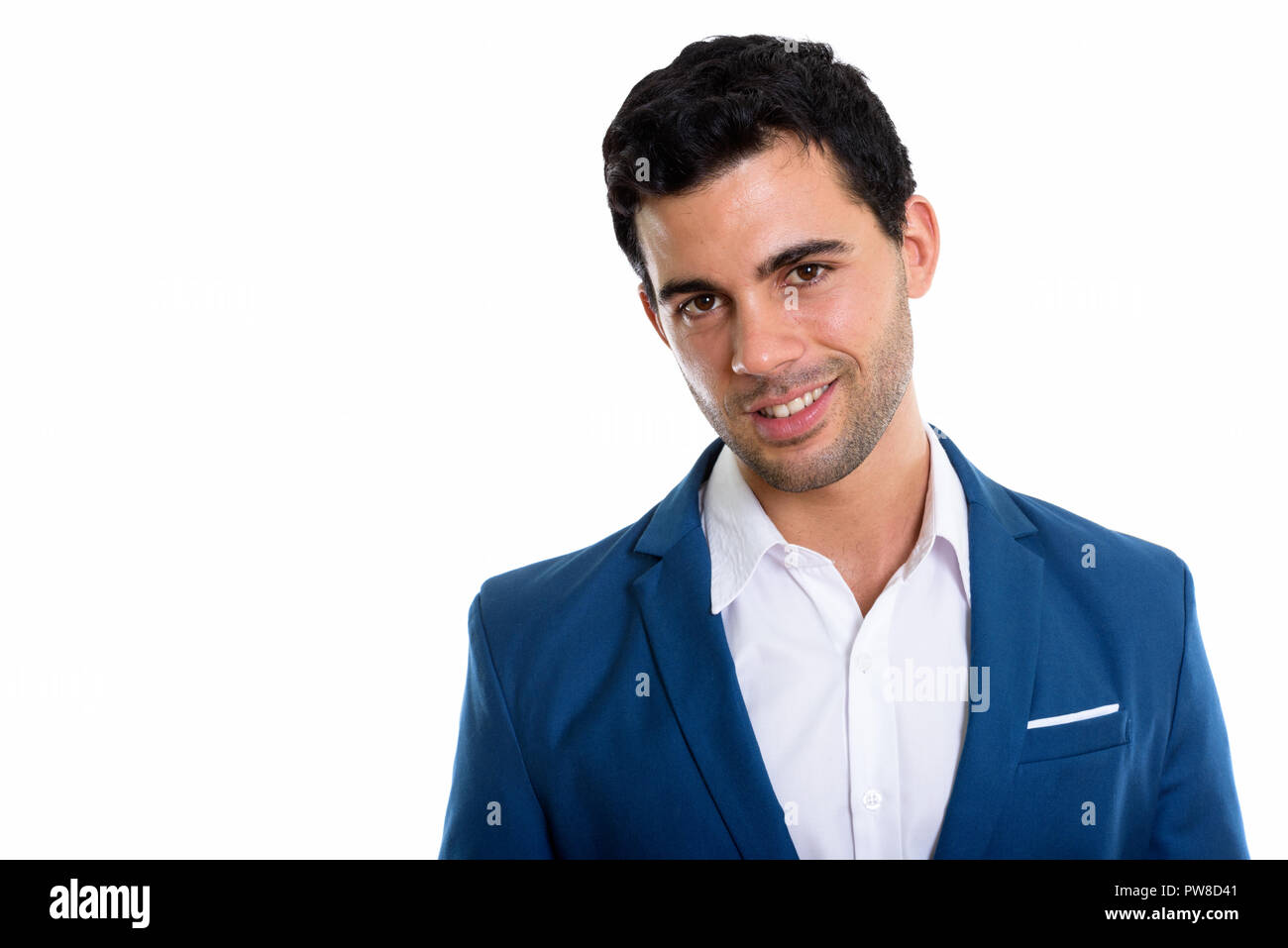 Studio shot of young happy Hispanic businessman smiling Stock Photo