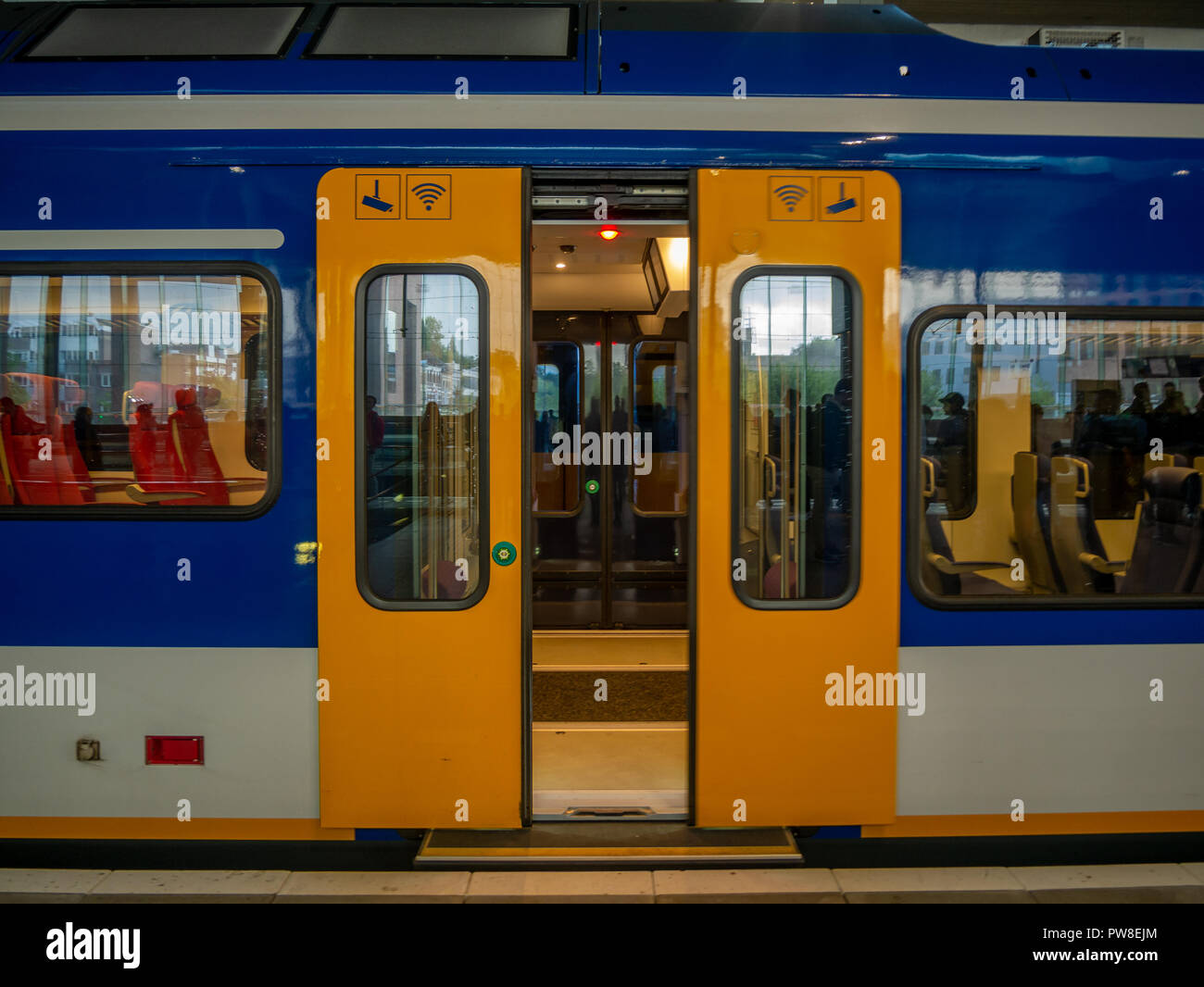 Breda, Netherlands - August 25, 2018 : Door of yellow train in railway station in the Netherlands. Stock Photo