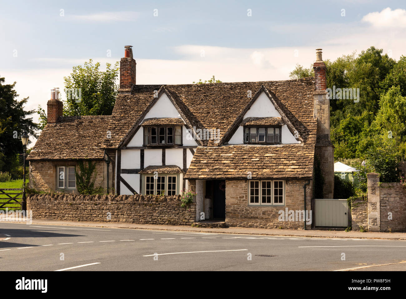 A traditional limewashed half timbered house in the village of Lacock, Wiltshire, England, UK Stock Photo
