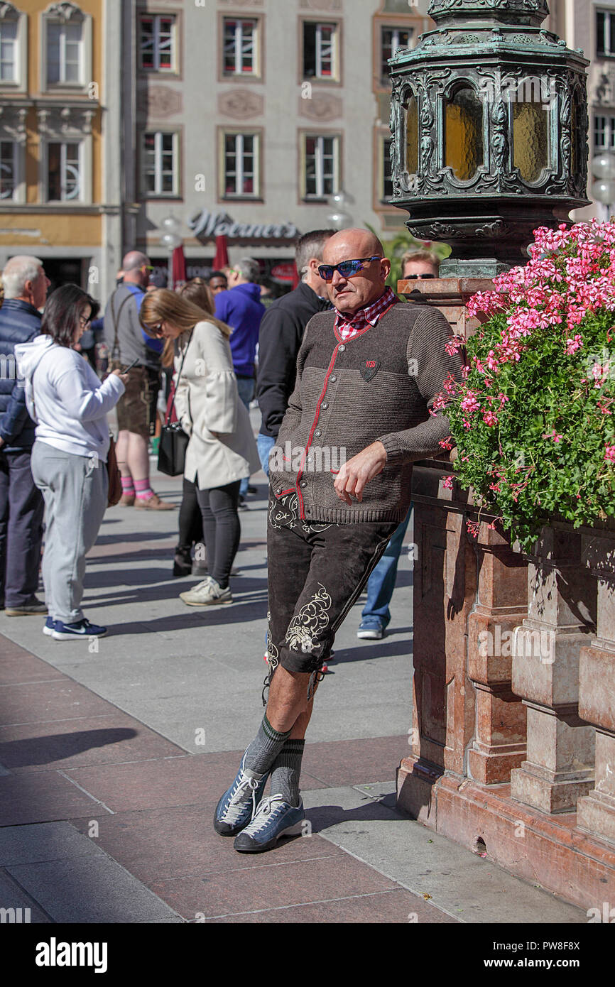 German male posing whilst having his photograph taken in the Marienplatz, Munich. Germany. Stock Photo