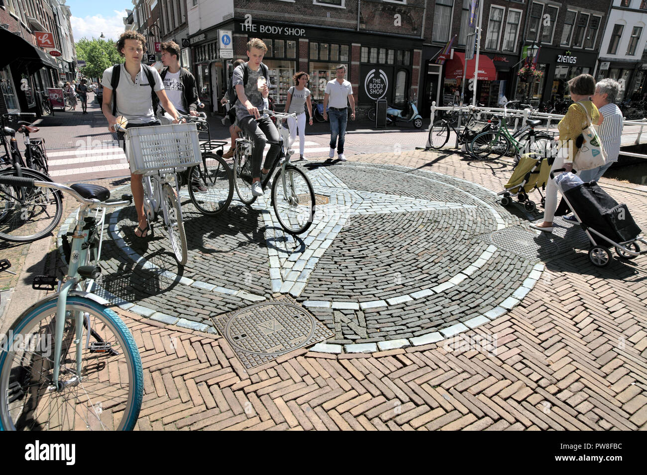 The four points of the compass set in brickwork in a pedestrianised part of  Delft town centre. South Holland, The Netherlands. Stock Photo