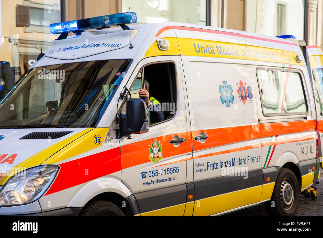 Flashibng lights on an italian ambulance in Florence attending to a patient in the city centre,Tuscany,Italy Stock Photo
