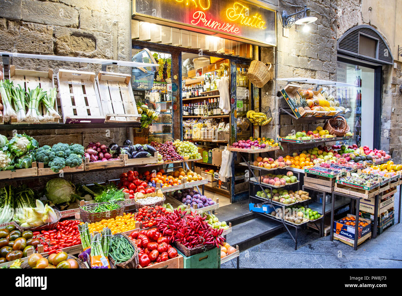 Greengrocer corner stall selling fresh fruit and vegetables in Florence city centre,Tuscany
