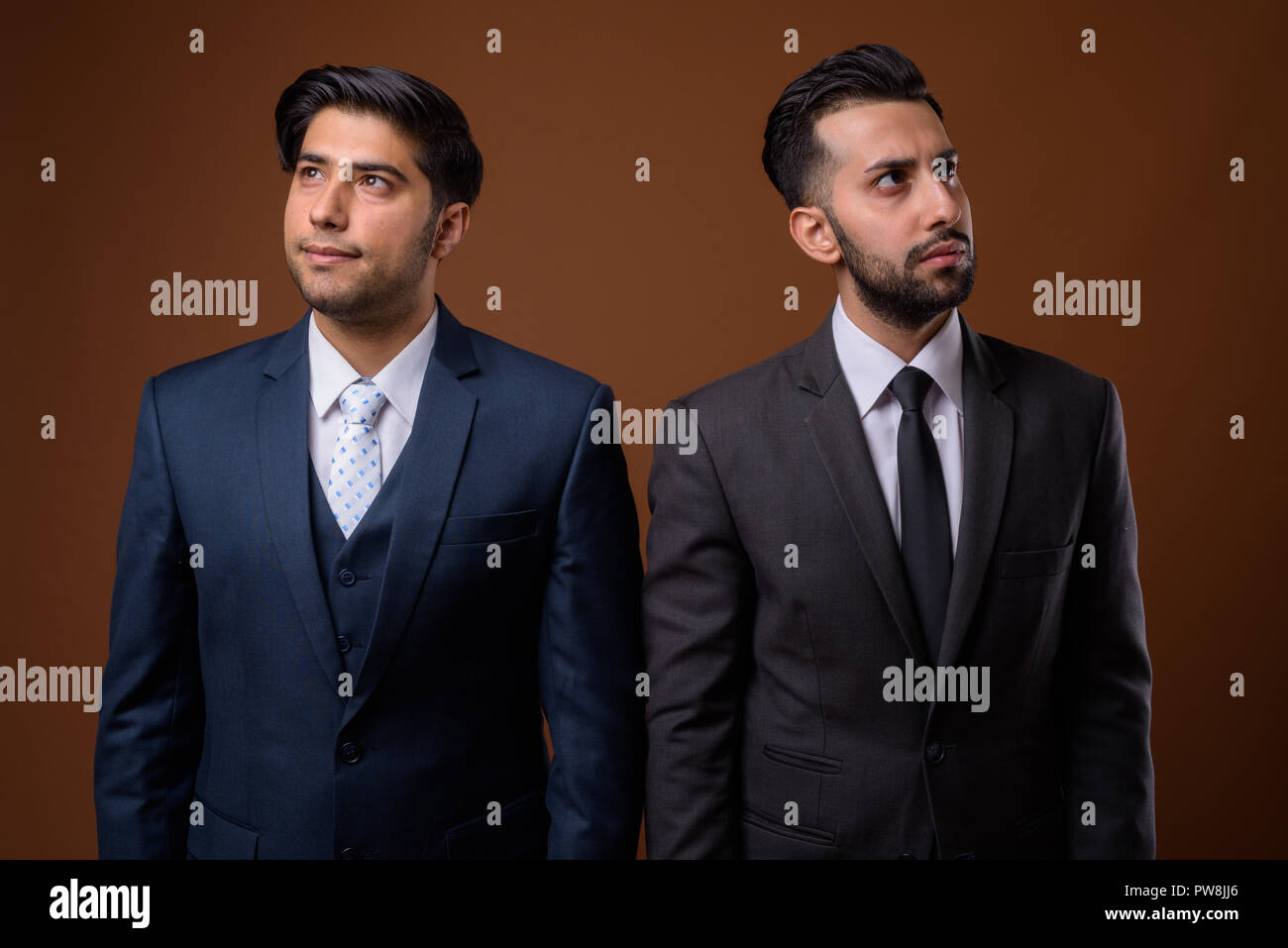 Studio shot of young handsome Iranian brothers together against  Stock Photo