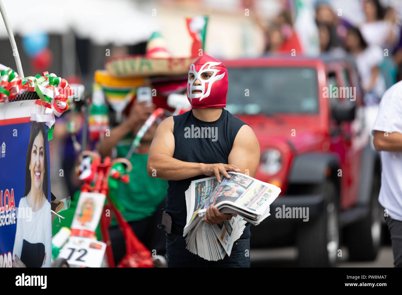 Chicago, Illinois , USA - September 9, 2018 The 26th Street Mexican Independence Parade, mexican man wearing a luchador mask giving away newspapers Stock Photo