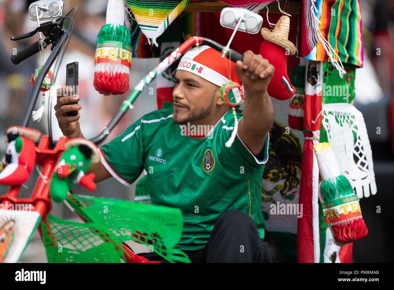 Chicago, Illinois , USA - September 9, 2018 The 26th Street Mexican Independence Parade, mexican man riding a bicycle with many representations of the Stock Photo