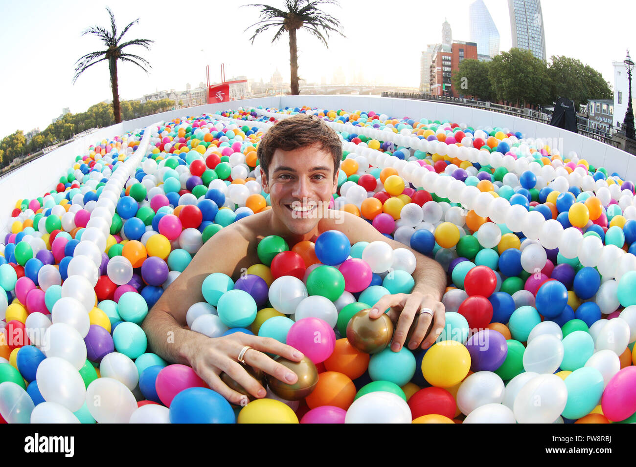 Tom Daley makes a splash in a giant outdoor ball-pit on London's Southbank.  Virgin Holidays is encouraging people to see the world as their playground  and dive into the 140,000-strong ball pool,