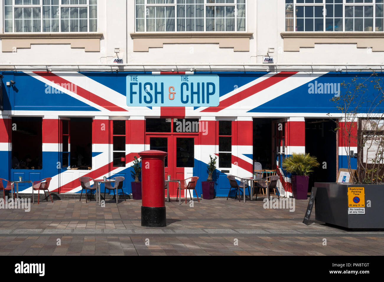 Exterior of 'The Fish and The Chip' restaurant painted with colourful red, white and blue Union Jack Flag, Jubilee Square, Leicester, England, UK Stock Photo