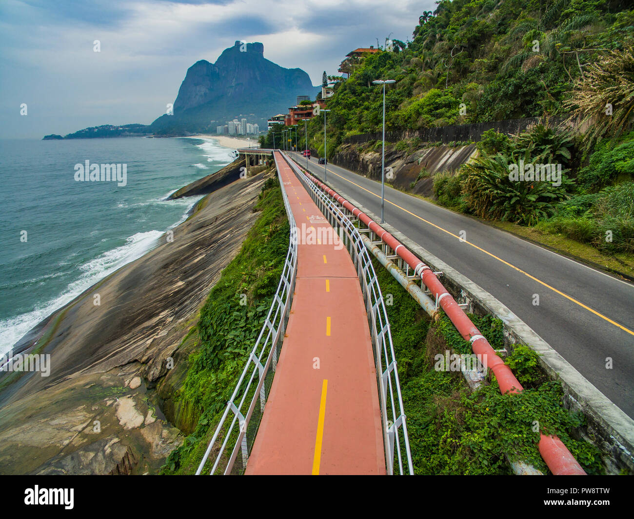 Highway by the sea. Wonderful road and bike path. Bicycle and road track and next to the blue sea in the city of Rio de Janeiro. Tim Maia bike path. Stock Photo
