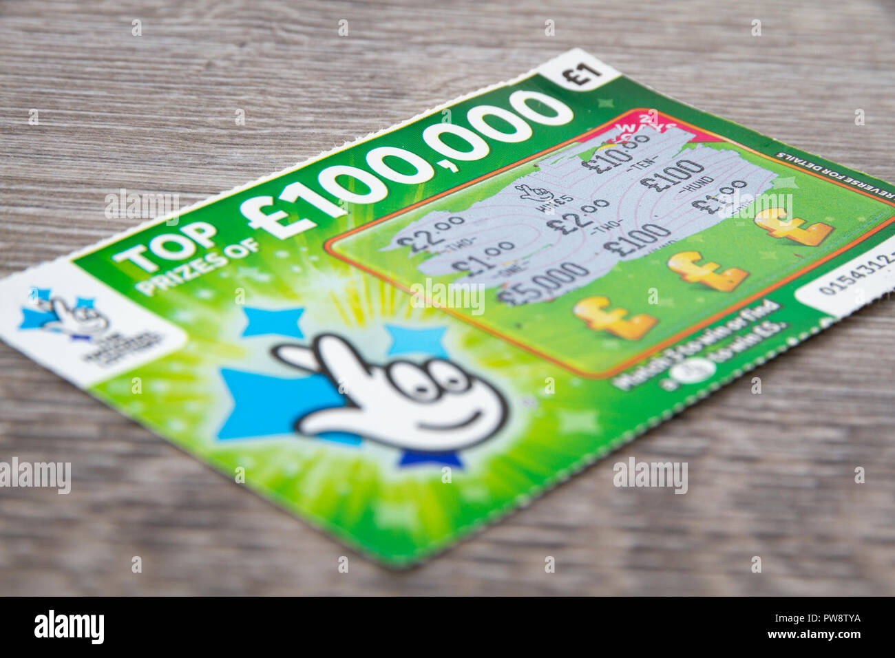 A National Lottery Scratchcard with a £5 win. Stock Photo