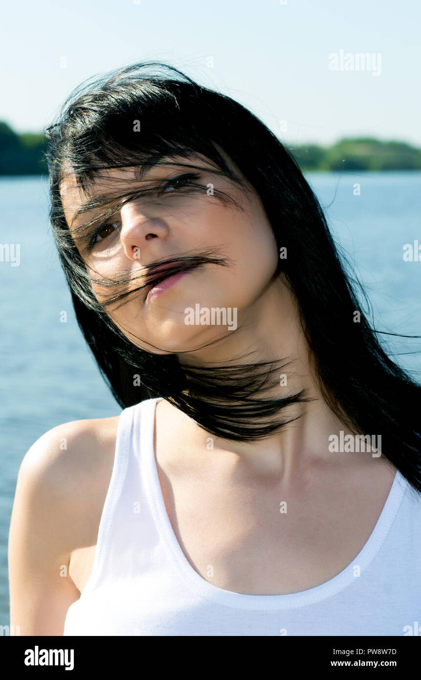Outdoors portrait of beautiful young brunette woman Stock Photo - Alamy