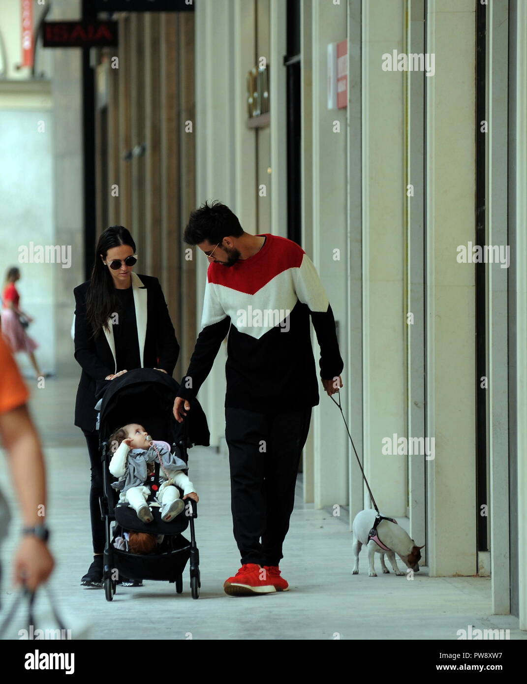 Milan, Nicolas Spolli and family shopping in the center Nicolas Spolli, the Argentine defender of GENOA, arrives in the center with his wife ANGELA and his daughter born a few months ago. After a long walk in Via Montenapoleone decide to enter from the 'IL GUFO' a shop specializing in the sale of clothes for children and babies and shopping. Stock Photo