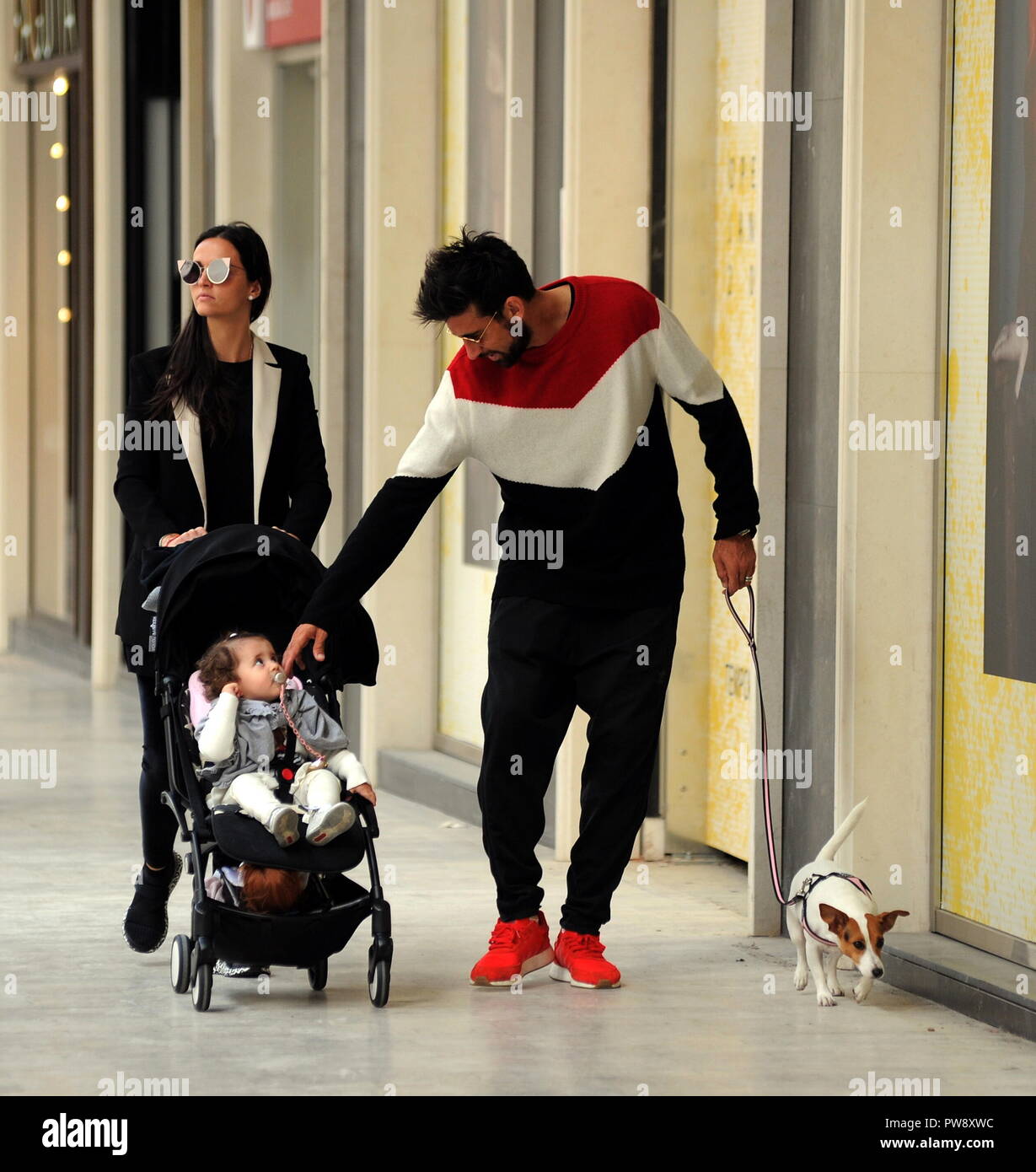 Milan, Nicolas Spolli and family shopping in the center Nicolas Spolli, the Argentine defender of GENOA, arrives in the center with his wife ANGELA and his daughter born a few months ago. After a long walk in Via Montenapoleone decide to enter from the 'IL GUFO' a shop specializing in the sale of clothes for children and babies and shopping. Stock Photo