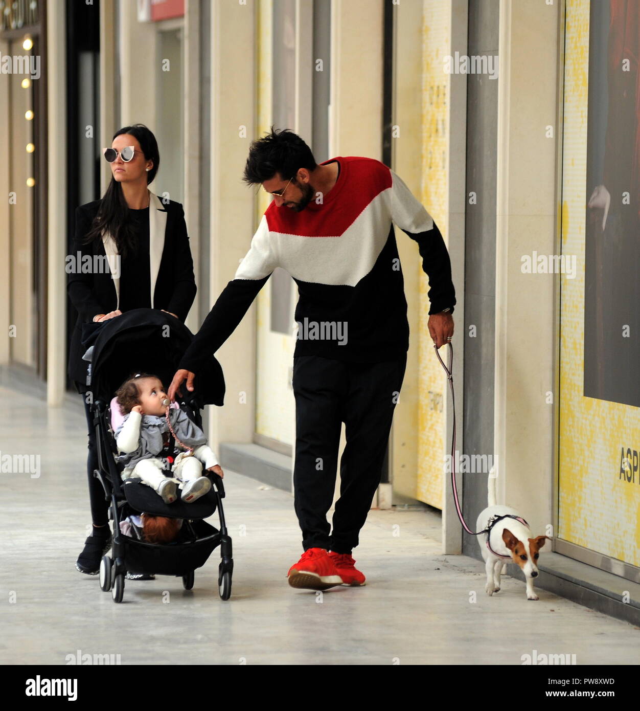 Milan, Nicolas Spolli and family shopping in the center Nicolas Spolli, the Argentine defender of GENOA, arrives in the center with his wife ANGELA and his daughter born a few months ago. After a long walk in Via Montenapoleone decide to enter from the 'IL GUFO' a shop specializing in the sale of clothes for children and babies and shopping. Stock Photo