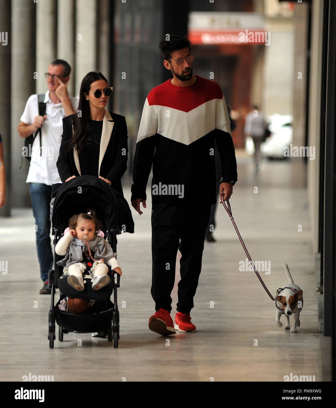 Milan, Nicolas Spolli and family shopping in the center Nicolas Spolli, the Argentine defender of GENOA, arrives in the center with his wife ANGELA and his daughter born a few months ago. After a long walk in Via Montenapoleone decide to enter from the 'IL GUFO' a shop specializing in the sale of clothes for children and babies and shopping. Stock Photo