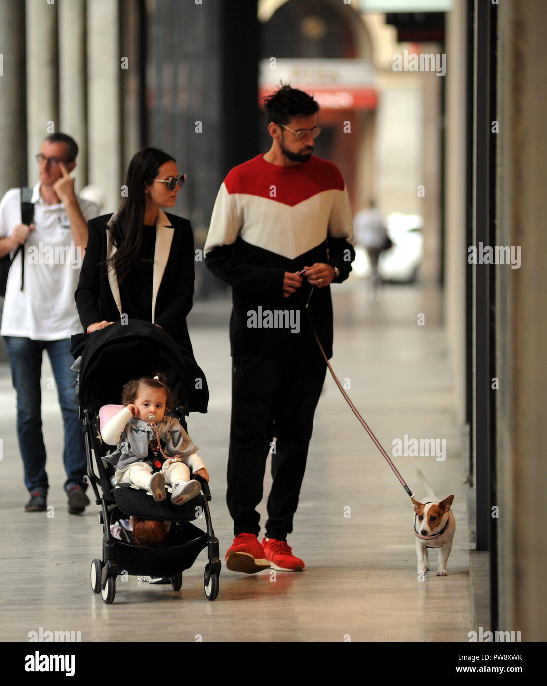 Milan, Nicolas Spolli and family shopping in the center Nicolas Spolli, the Argentine defender of GENOA, arrives in the center with his wife ANGELA and his daughter born a few months ago. After a long walk in Via Montenapoleone decide to enter from the 'IL GUFO' a shop specializing in the sale of clothes for children and babies and shopping. Stock Photo