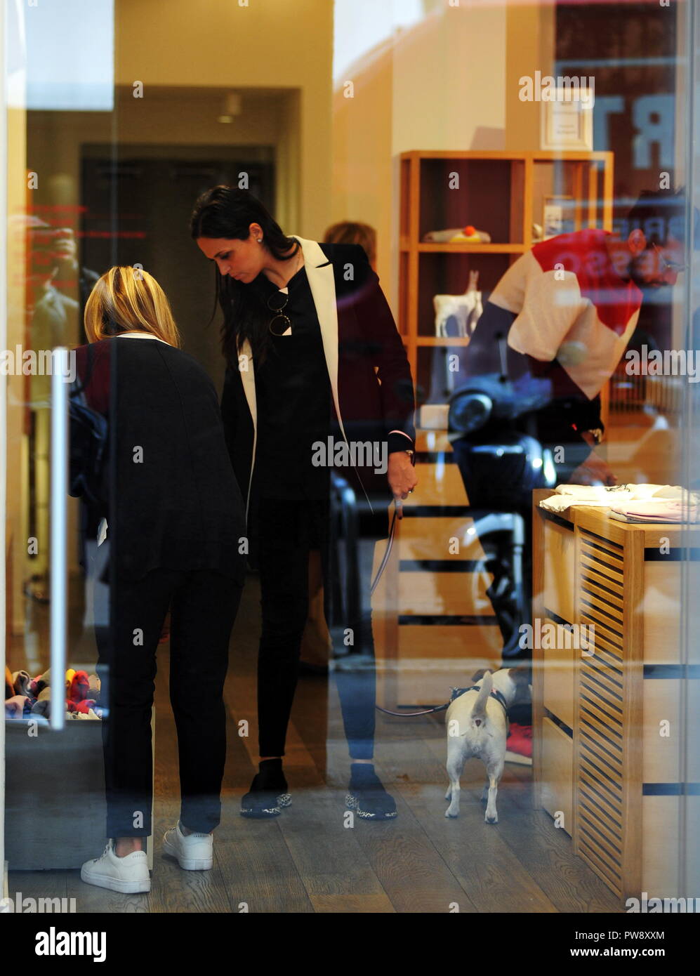 Milan, Nicolas Spolli and family shopping in the center Nicolas Spolli, the Argentine defender of GENOA, arrives in the center with his wife ANGELA and his daughter born a few months ago. After a long walk in Via Montenapoleone decide to enter from the 'IL GUFO' a shop specializing in the sale of clothes for children and babies and shopping. Stock Photo