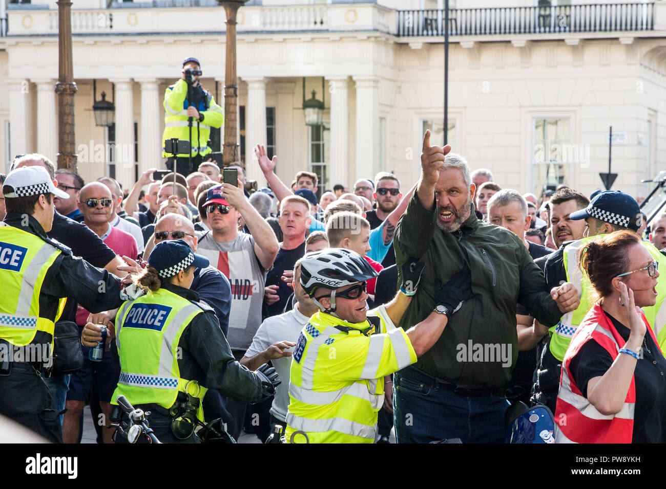 London, UK. 13th October, 2018. Supporters of the far-right Democratic Football Lads Alliance (DFLA) push against a police cordon after anti-fascist groups including many women from the Feminist Anti-Fascist Assembly blocked the route of their demonstration through London. Anti-racist groups also held a Unity demonstration to coincide with the DFLA demonstration. Credit: Mark Kerrison/Alamy Live News Stock Photo