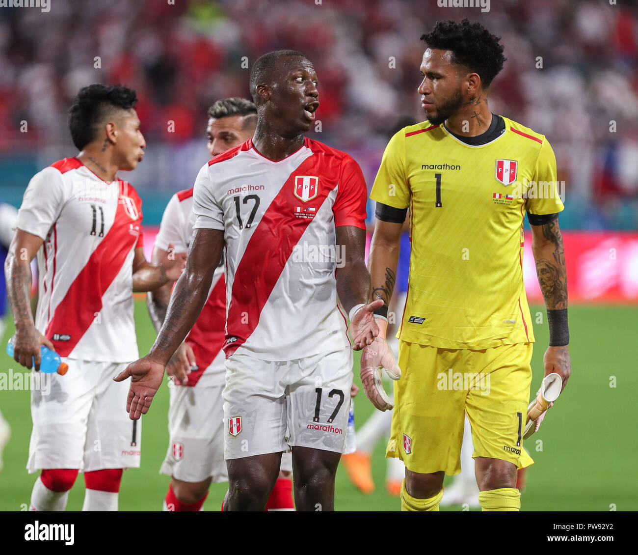 Miami Gardens, Florida, USA. 12th Oct, 2018. Peru defender LUIS ADVINCULA (17) talks to goalkeeper PEDRO GALLESE (1) as they exit the field after the first half of an international friendly match between the Peru and Chile national soccer teams, at the Hard Rock Stadium in Miami Gardens, Florida. Credit: Mario Houben/ZUMA Wire/Alamy Live News Stock Photo