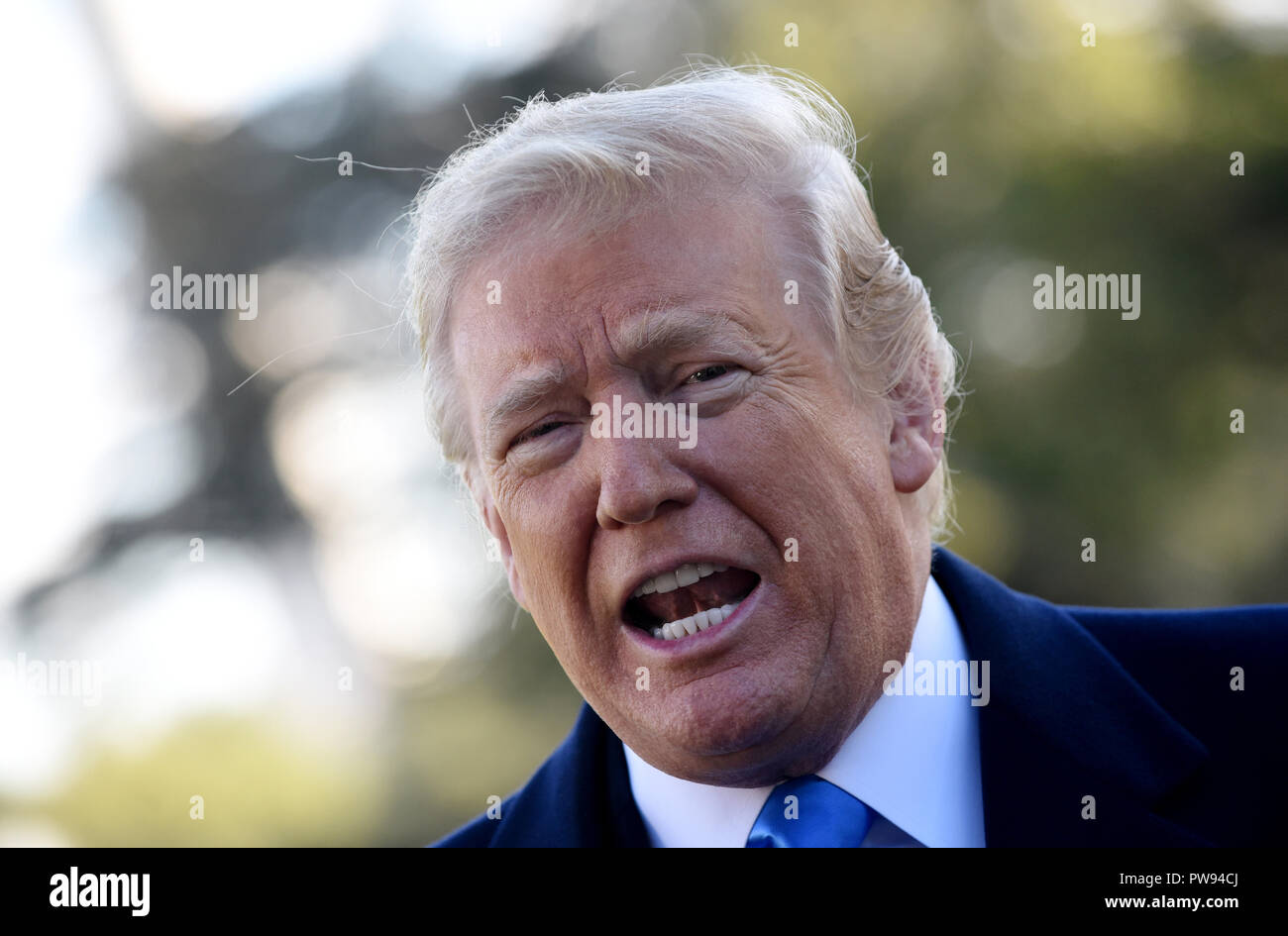 U.S. President Donald Trump speaks to reporters on the South Lawn before boarding Marine One at the White House, on October 13, 2018 in Washington, DC. President Trump is traveling to Kentucky. Credit: Olivier Douliery/Pool via CNP/MediaPunch Stock Photo