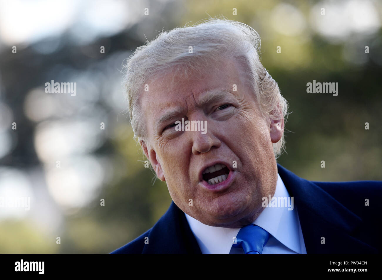 U.S. President Donald Trump speaks to reporters on the South Lawn before boarding Marine One at the White House, on October 13, 2018 in Washington, DC. President Trump is traveling to Kentucky. Credit: Olivier Douliery/Pool via CNP/MediaPunch Stock Photo