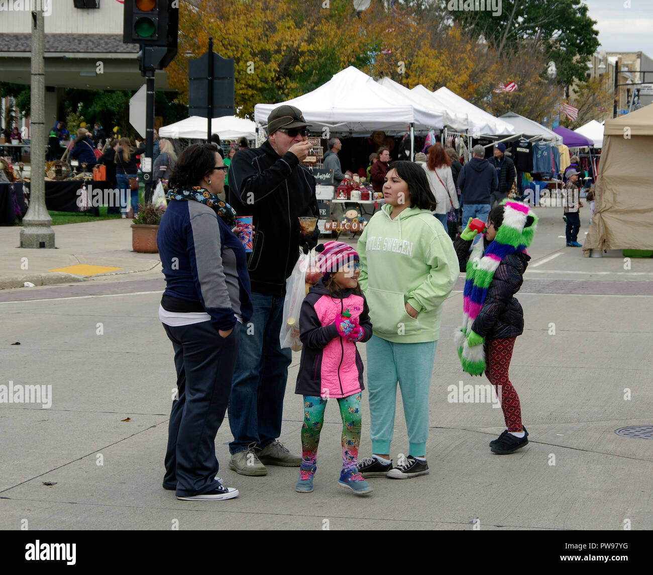 Two Rivers, Wisconsin USA, 13th Oct, 2018. Family pauses for refreshment while enjoying the street fair at Two Rivers Annual Autumn Applefest. Credit: Jerome Wilson/Alamy Live News Stock Photo