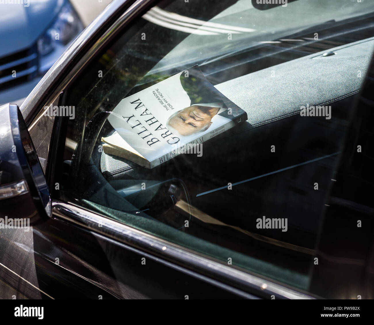 The Billy Graham Book 'The Reason For My Hope' left in the dash of a car. Stock Photo