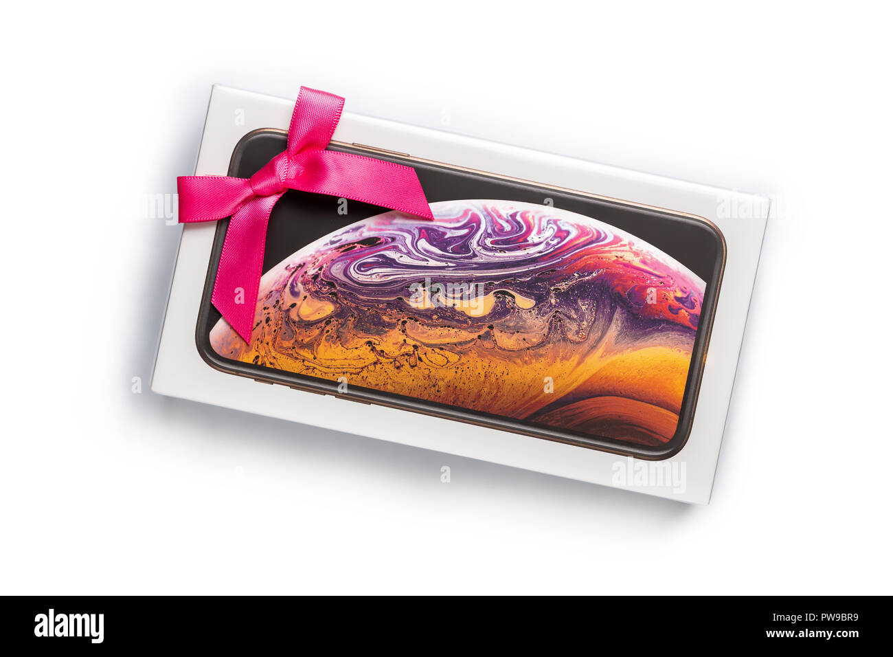 12th October,2018-Kiev,Ukraine: Latest Apple Iphone XS in unopened box on white table with pink bow attached. Best present in gift wrap . Most wanted gift. Isolated on white Stock Photo
