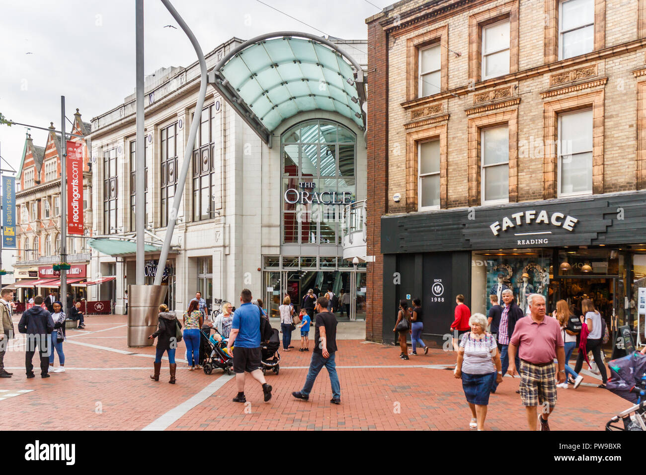 Reading, England - 1st June 2018: People walking past the entrance to the Oracle shopping centre. The mall attracts shoppers from all over the region. Stock Photo
