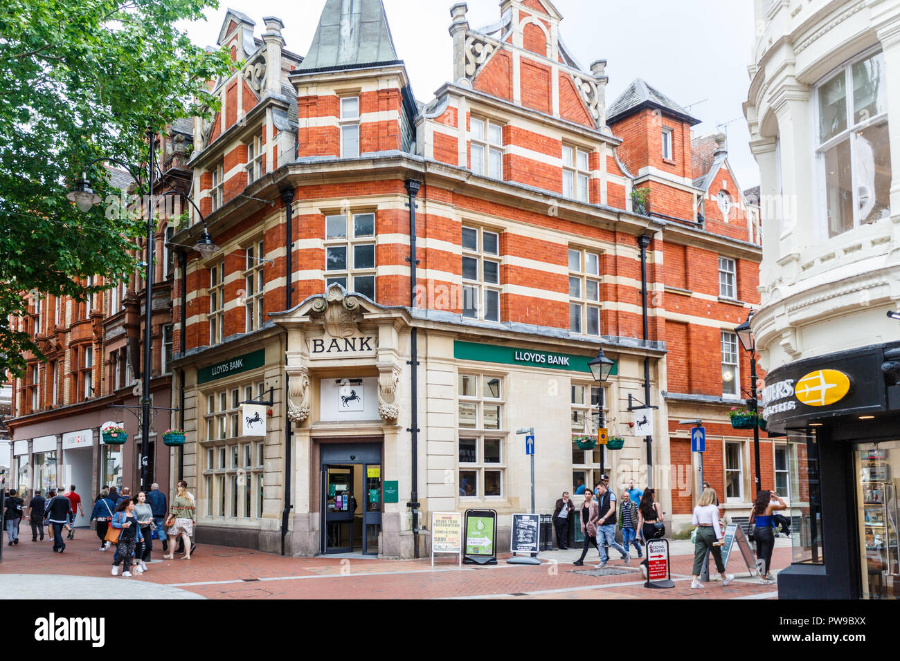 Reading, England - 1st June 2018: People walking past Lloyds Bank. Llotds is an old established UK bank. Stock Photo