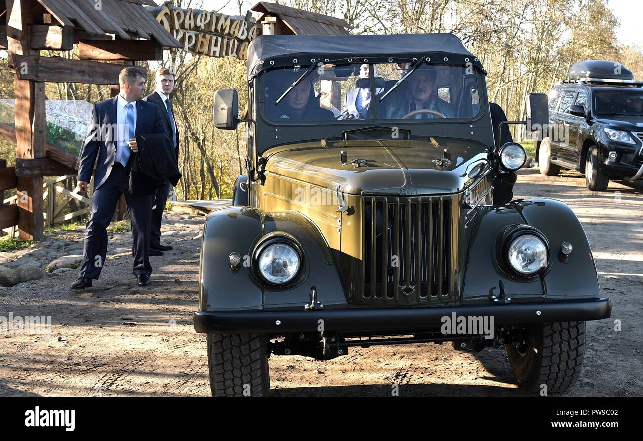 Russian President Vladimir Putin, left, is given a tour of the Alexandria agricultural community by Belarus President Alexander Lukashenko from an old army jeep October 12, 2018 n Sokolowski District, Belarus. Lukashenko was born and raised in the community. Stock Photo
