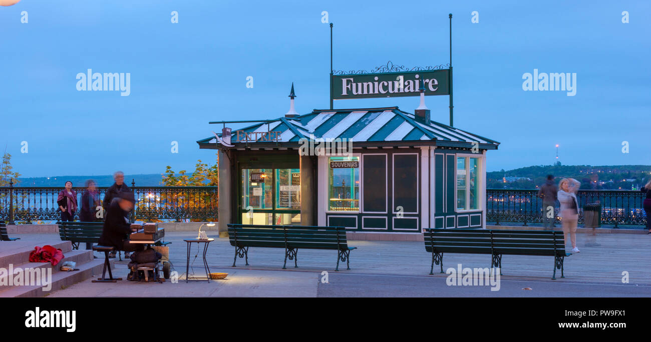 The upper level station of the Old Quebec Funicular, on the Dufferin Terrace. A local street performer entertains tourists. Quebec City, Canada Stock Photo