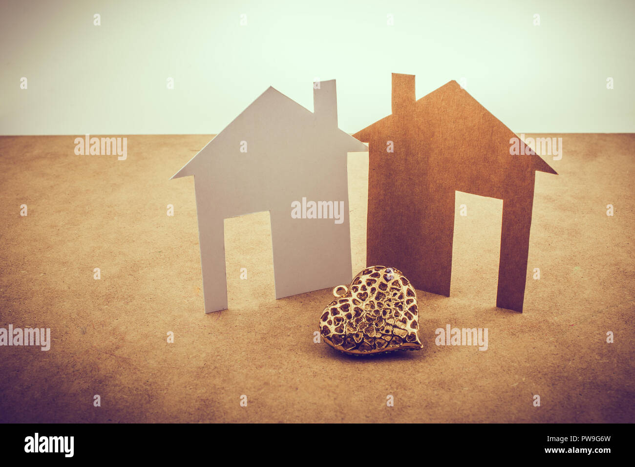 Heart shaped icon and paper houses on a brown background Stock Photo ...