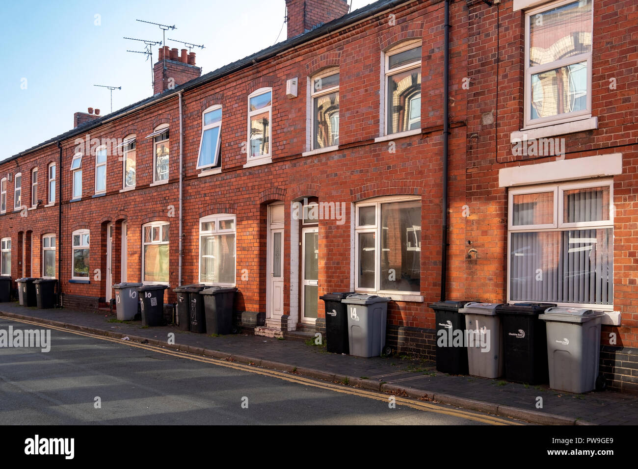 Row of rubbish bins outside terraced houses ready for collection in Crewe  Cheshire UK Stock Photo - Alamy