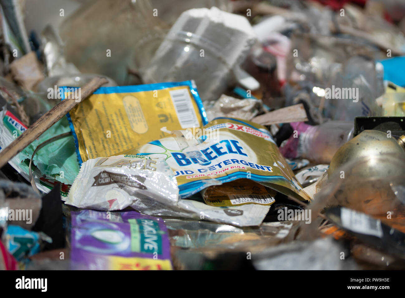 Single use plastic sachets discarded directly into the environment - regarded as one of the main plastic pollutants within South East Asia. Stock Photo
