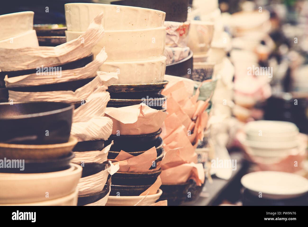 Japanese food bowls and tableware for sale at a market in Osaka, Japan. Retro style filter applied. Stock Photo