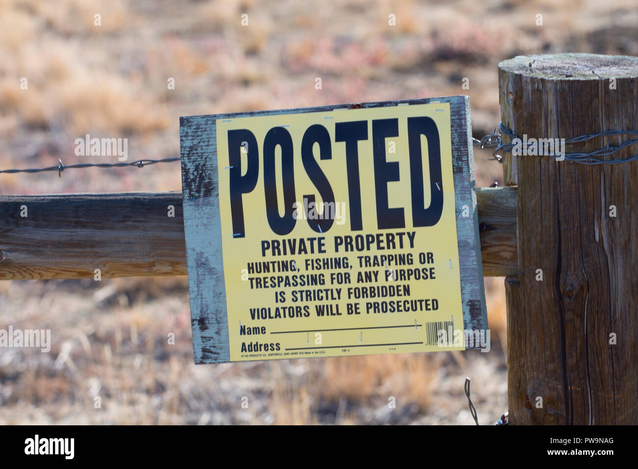 No trespassing, No hunting, No fishing, No trapping sign on fence