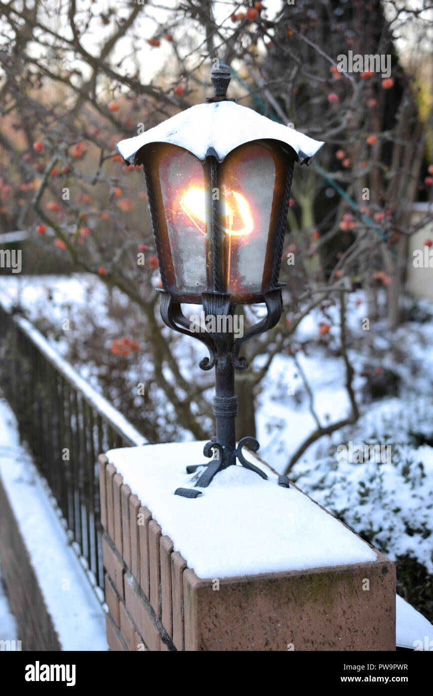 lantern on neighborhood garden fence christmas card winter Stock Photo