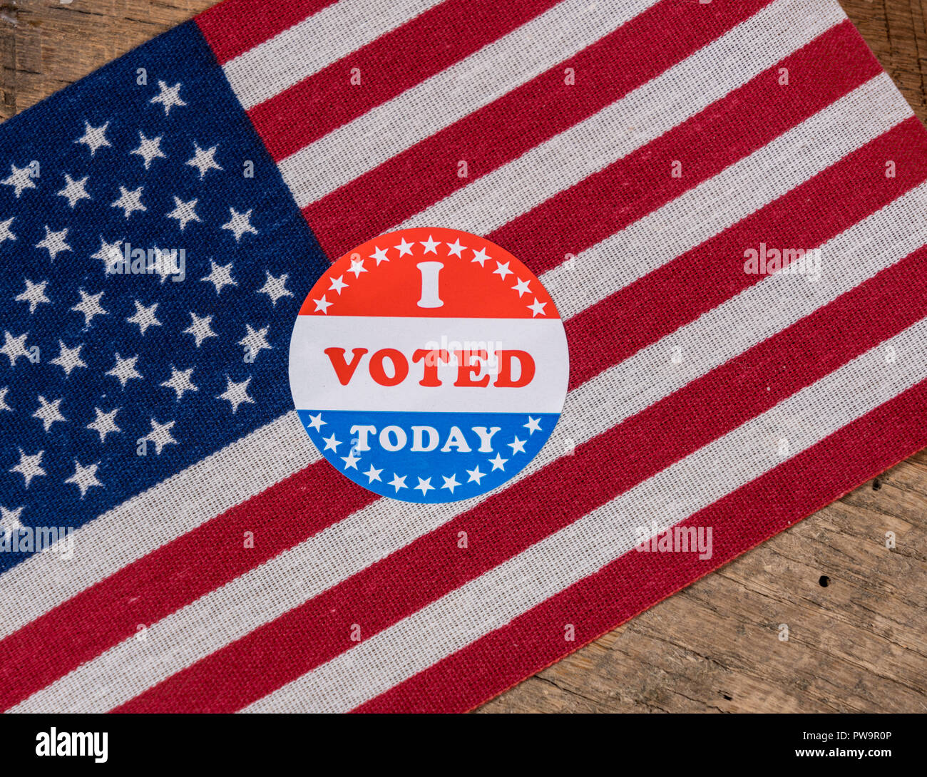 I Voted Today paper sticker on US Flag and rural wooden table Stock Photo